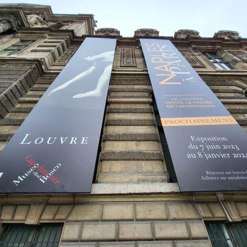 Banners hanging from the Louvre in Paris, France.